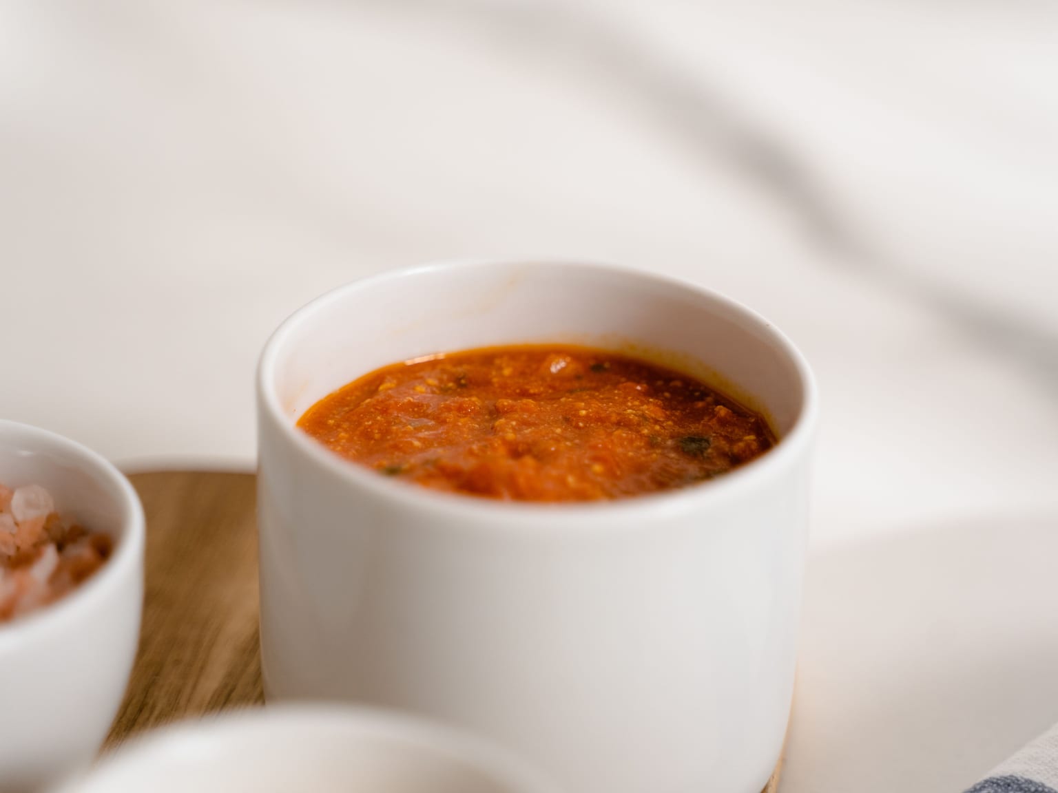 Rustic Italian tomato sauce in a shallow bowl with visible garlic and torn basil
