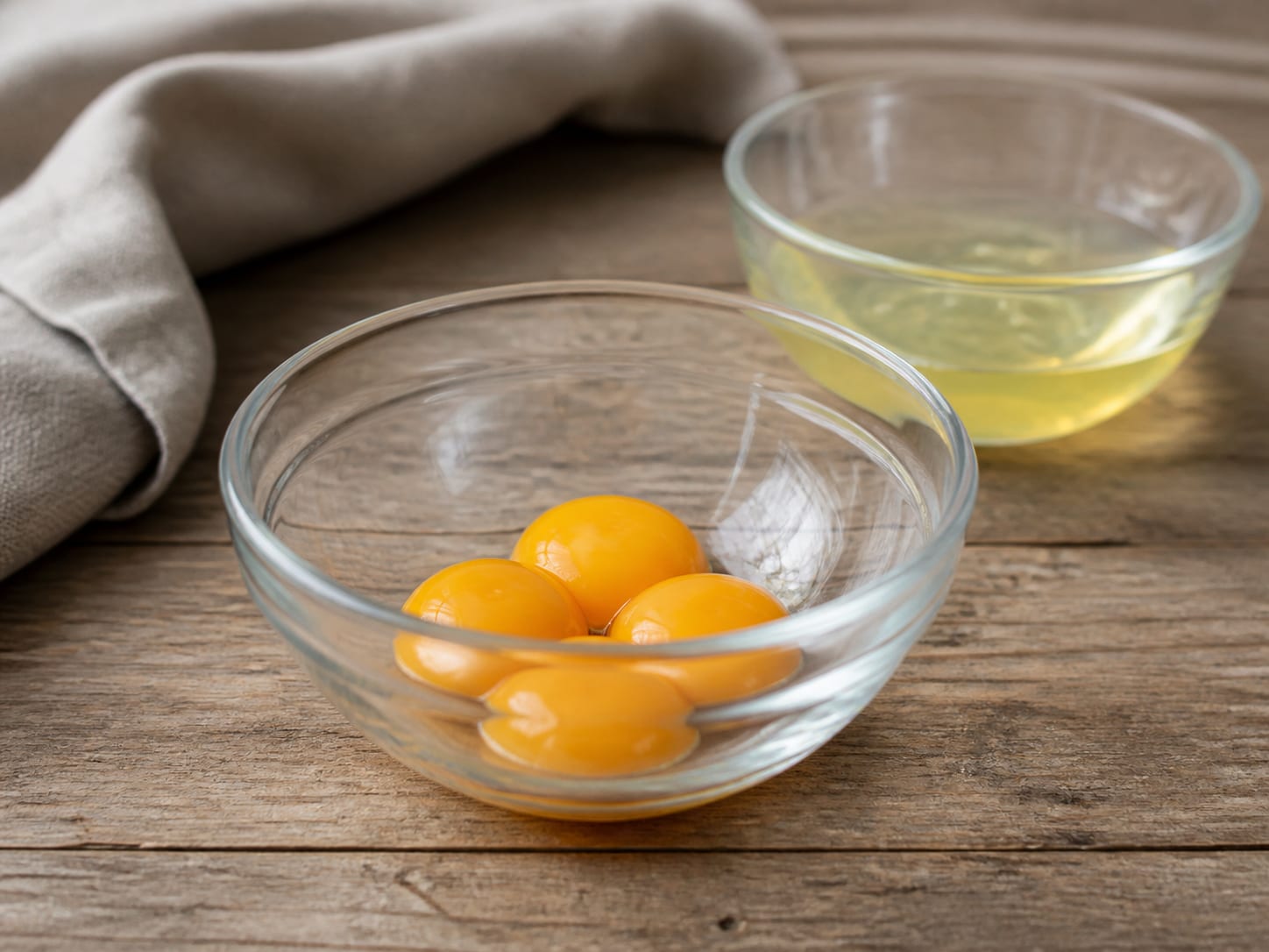 Egg yolks separated from the whites in small bowls